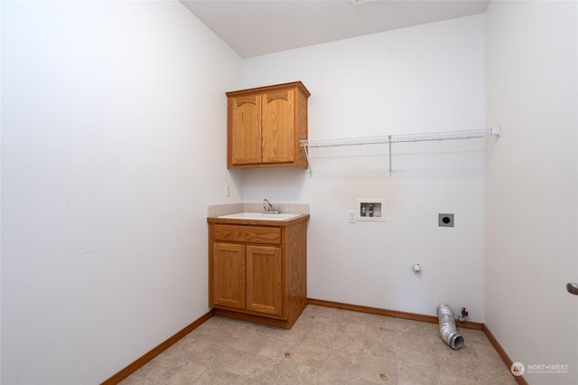 clothes washing area featuring electric dryer hookup, sink, hookup for a washing machine, hookup for a gas dryer, and cabinets