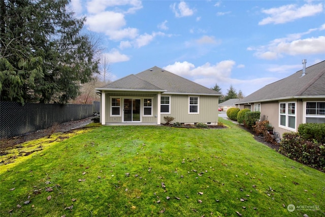 rear view of house with a yard