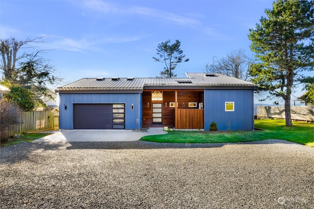 view of front of home with a garage and solar panels