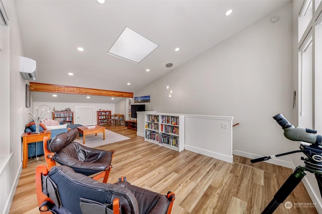 interior space with an AC wall unit, vaulted ceiling with skylight, and light wood-type flooring