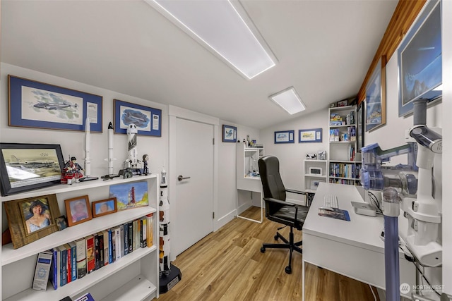 office area with vaulted ceiling and light hardwood / wood-style flooring