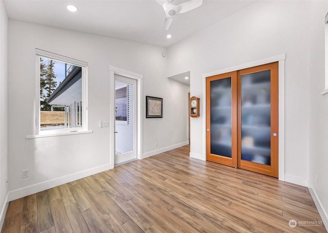 unfurnished room with ceiling fan and light wood-type flooring