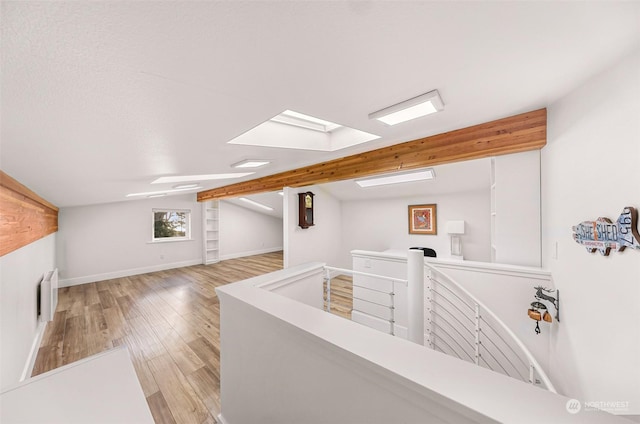 interior space with lofted ceiling and light hardwood / wood-style floors