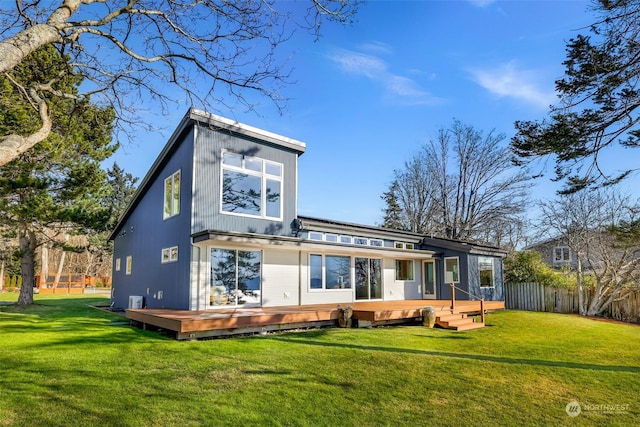 back of house featuring a yard and a deck