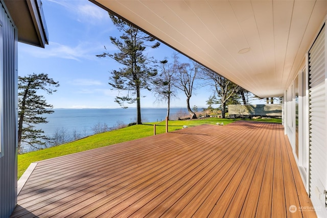 wooden deck featuring a water view and a lawn