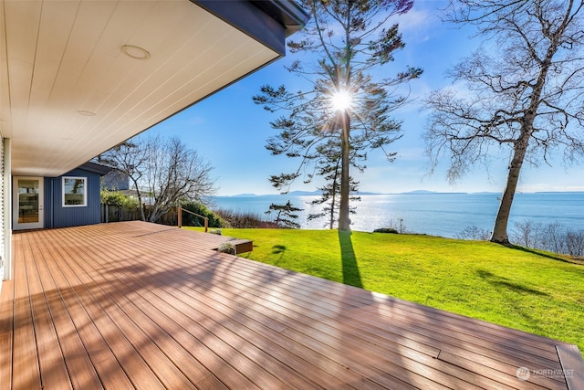 wooden terrace featuring a water and mountain view and a lawn