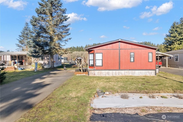 view of side of property with a lawn