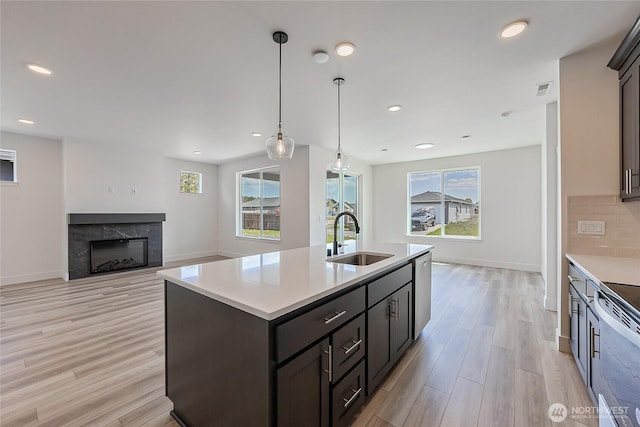 402 Pagget Ave, Winlock, WA 98596 - kitchen with a sink, light countertops, light wood finished floors, plenty of natural light, and recessed lighting