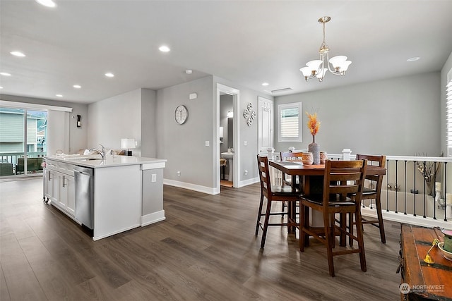 kitchen featuring pendant lighting, sink, white cabinetry, an island with sink, and stainless steel dishwasher