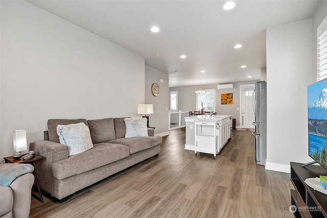 living room featuring hardwood / wood-style flooring and a chandelier