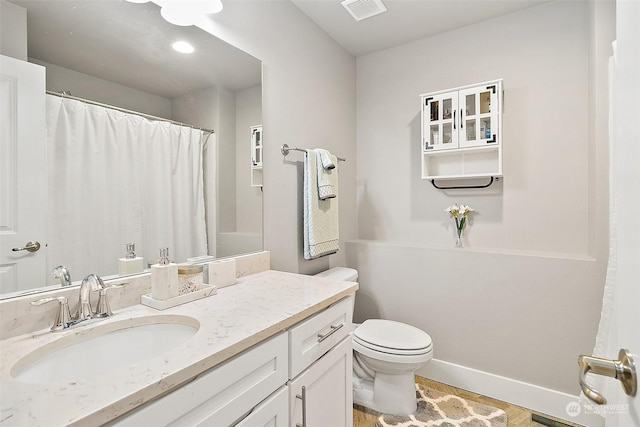 bathroom featuring hardwood / wood-style flooring, vanity, and toilet