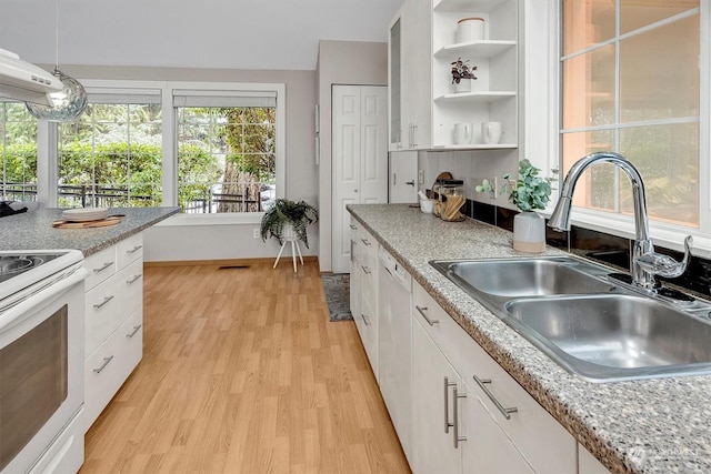 kitchen with white appliances, light hardwood / wood-style floors, sink, and white cabinets