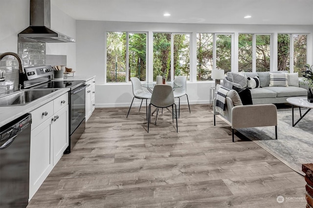 kitchen featuring white cabinetry, dishwasher, sink, wall chimney range hood, and electric stove