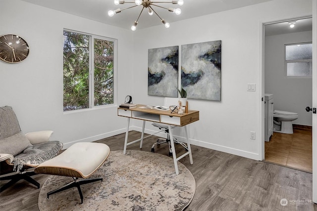 home office featuring hardwood / wood-style floors and a chandelier