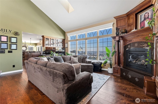 living room with dark wood-type flooring and high vaulted ceiling