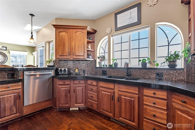 kitchen featuring pendant lighting, sink, dishwasher, backsplash, and dark hardwood / wood-style floors