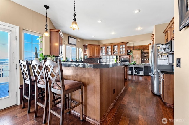 kitchen with a kitchen breakfast bar, dark hardwood / wood-style flooring, and decorative light fixtures