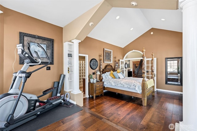 bedroom with dark wood-type flooring, vaulted ceiling, and ornate columns