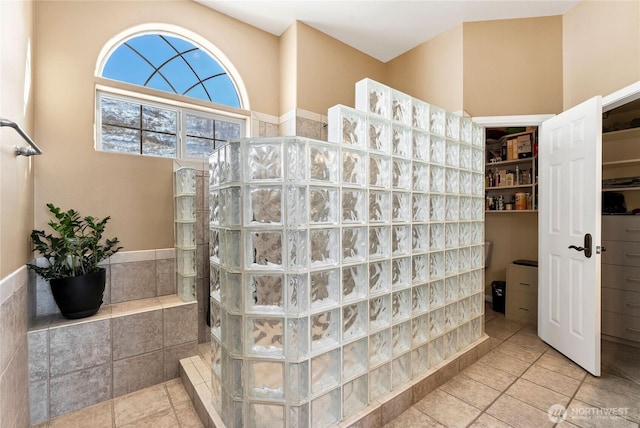 bathroom with tile patterned floors and walk in shower