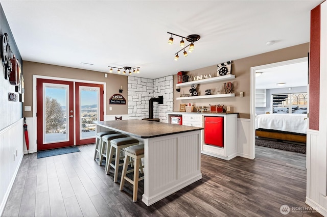 kitchen featuring french doors, a breakfast bar, dark hardwood / wood-style flooring, and a center island