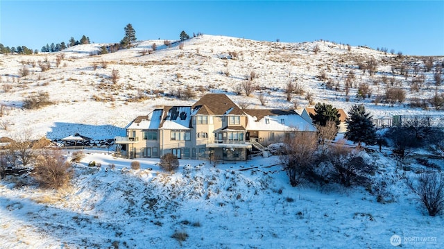 snowy aerial view with a mountain view