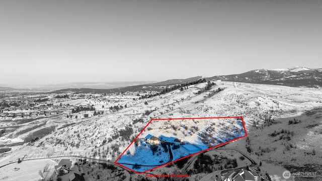 snowy aerial view featuring a mountain view