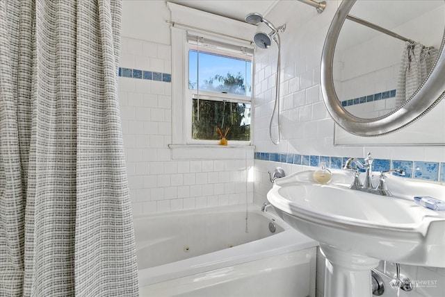 bathroom with tile walls and shower / bath combo