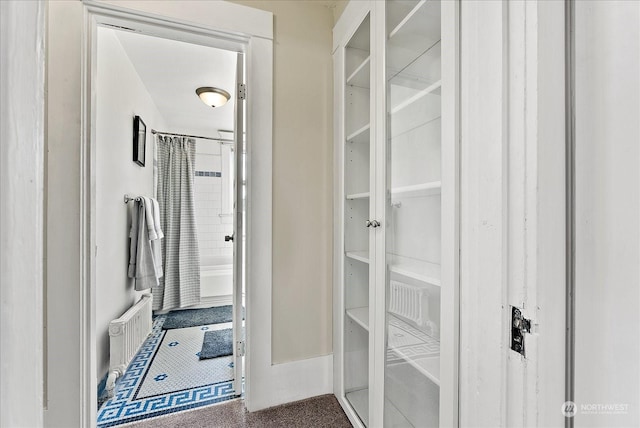 spacious closet with radiator heating unit