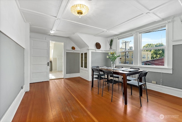 dining room featuring coffered ceiling and wood-type flooring