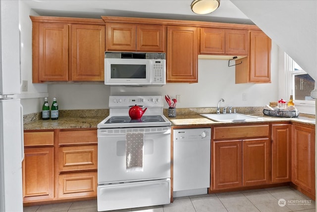 kitchen with sink, white appliances, and light tile patterned flooring