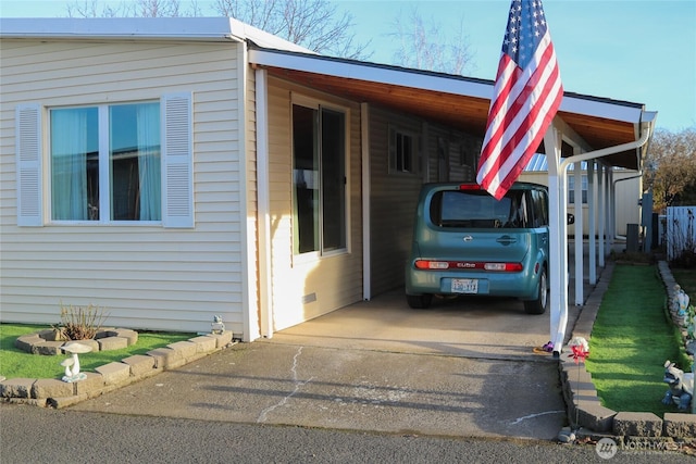 view of side of home featuring a carport and driveway