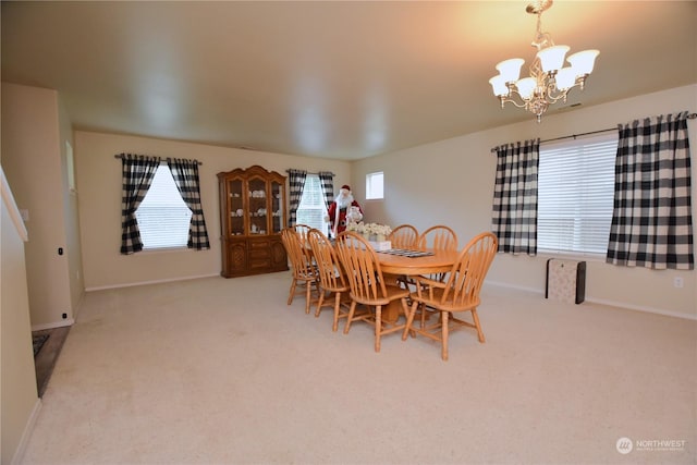 carpeted dining space with plenty of natural light and an inviting chandelier