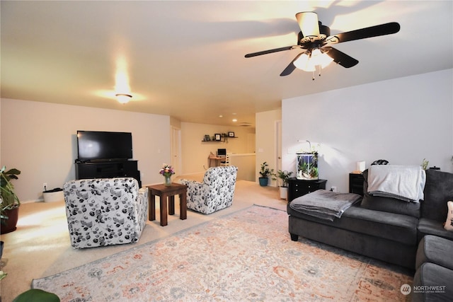 carpeted living room featuring ceiling fan