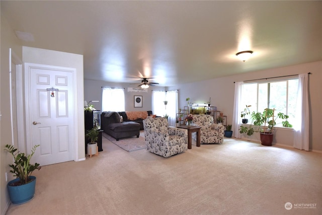 living room featuring light colored carpet and ceiling fan