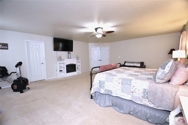 carpeted bedroom with ceiling fan and a closet