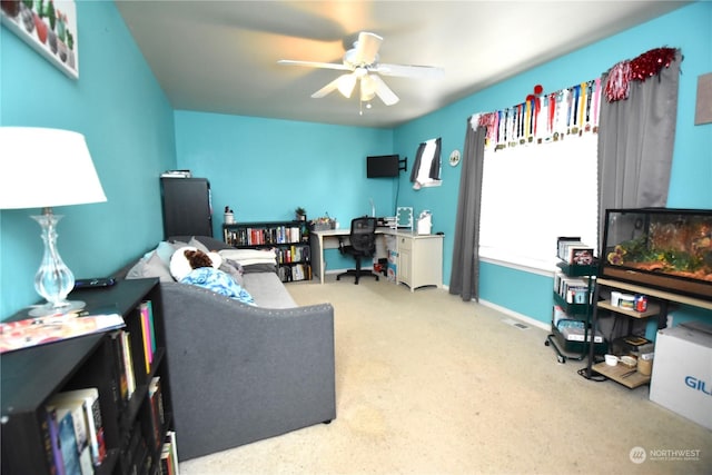 carpeted home office with ceiling fan