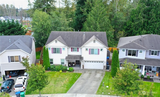 view of front of property with a garage and a front lawn