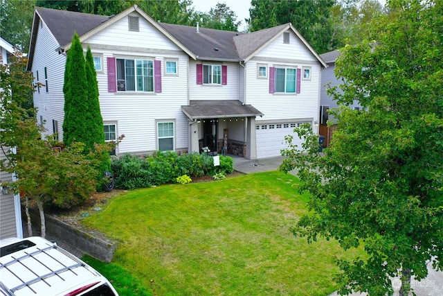 view of front of property featuring a garage and a front lawn