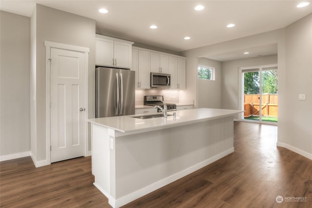 kitchen featuring sink, white cabinetry, stainless steel appliances, an island with sink, and dark hardwood / wood-style flooring