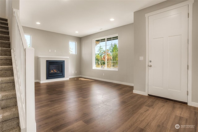 unfurnished living room with dark hardwood / wood-style flooring