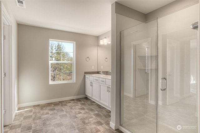 bathroom featuring walk in shower and vanity