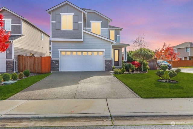 view of front of home featuring a garage and a lawn