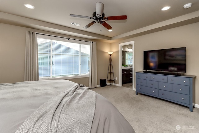 carpeted bedroom with ceiling fan and ensuite bathroom