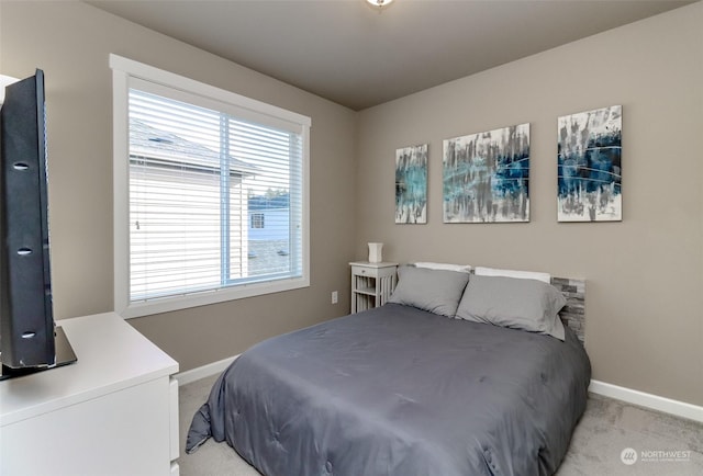 bedroom featuring light carpet