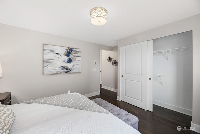 bedroom with dark wood-type flooring and a closet