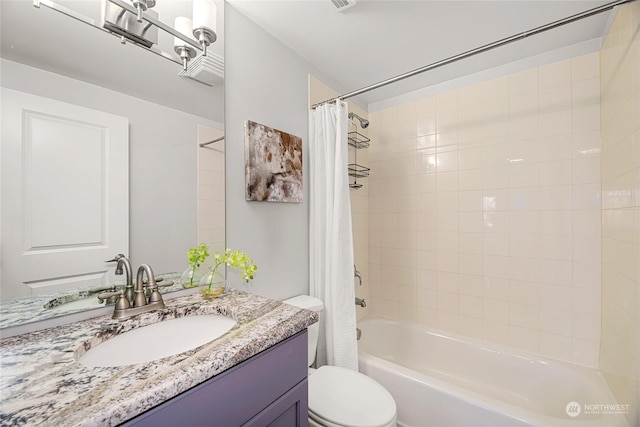 full bathroom featuring shower / bath combination with curtain, vanity, and toilet