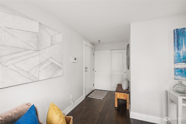 corridor with dark hardwood / wood-style floors