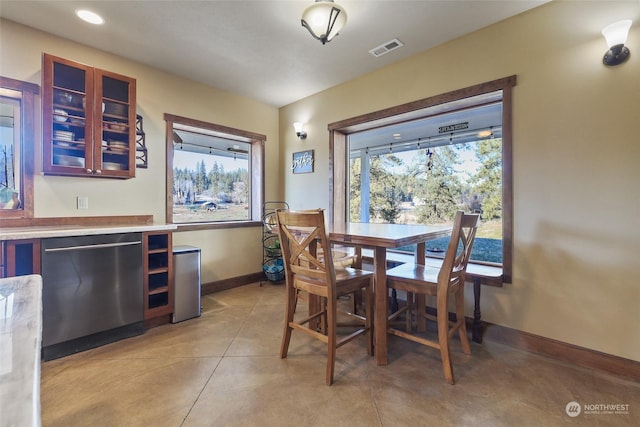 dining space featuring light tile patterned floors and a wealth of natural light