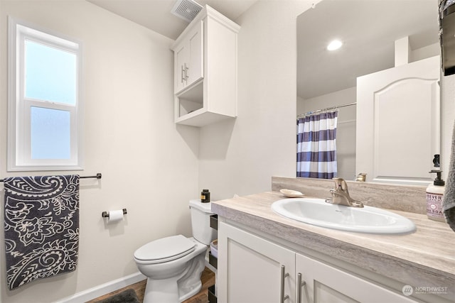 bathroom featuring vanity, toilet, and hardwood / wood-style flooring