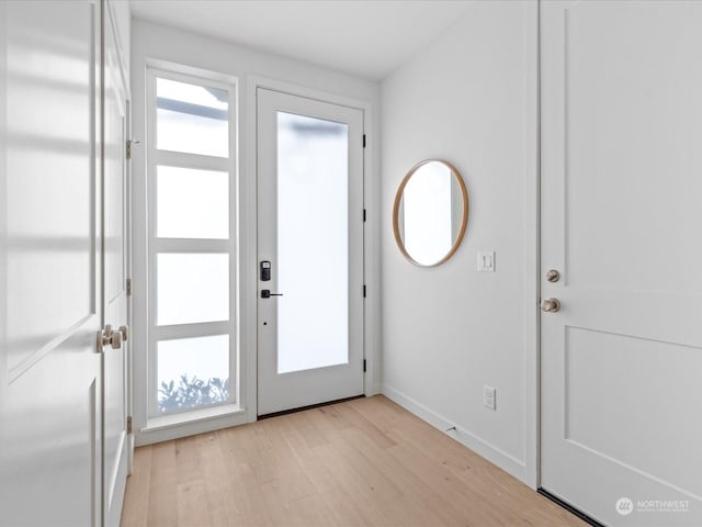 doorway to outside with light hardwood / wood-style flooring